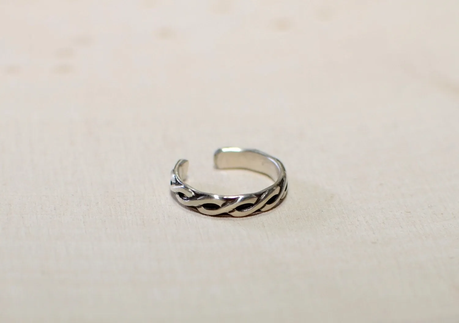 Toe ring in sterling silver with braided pattern and dark patina